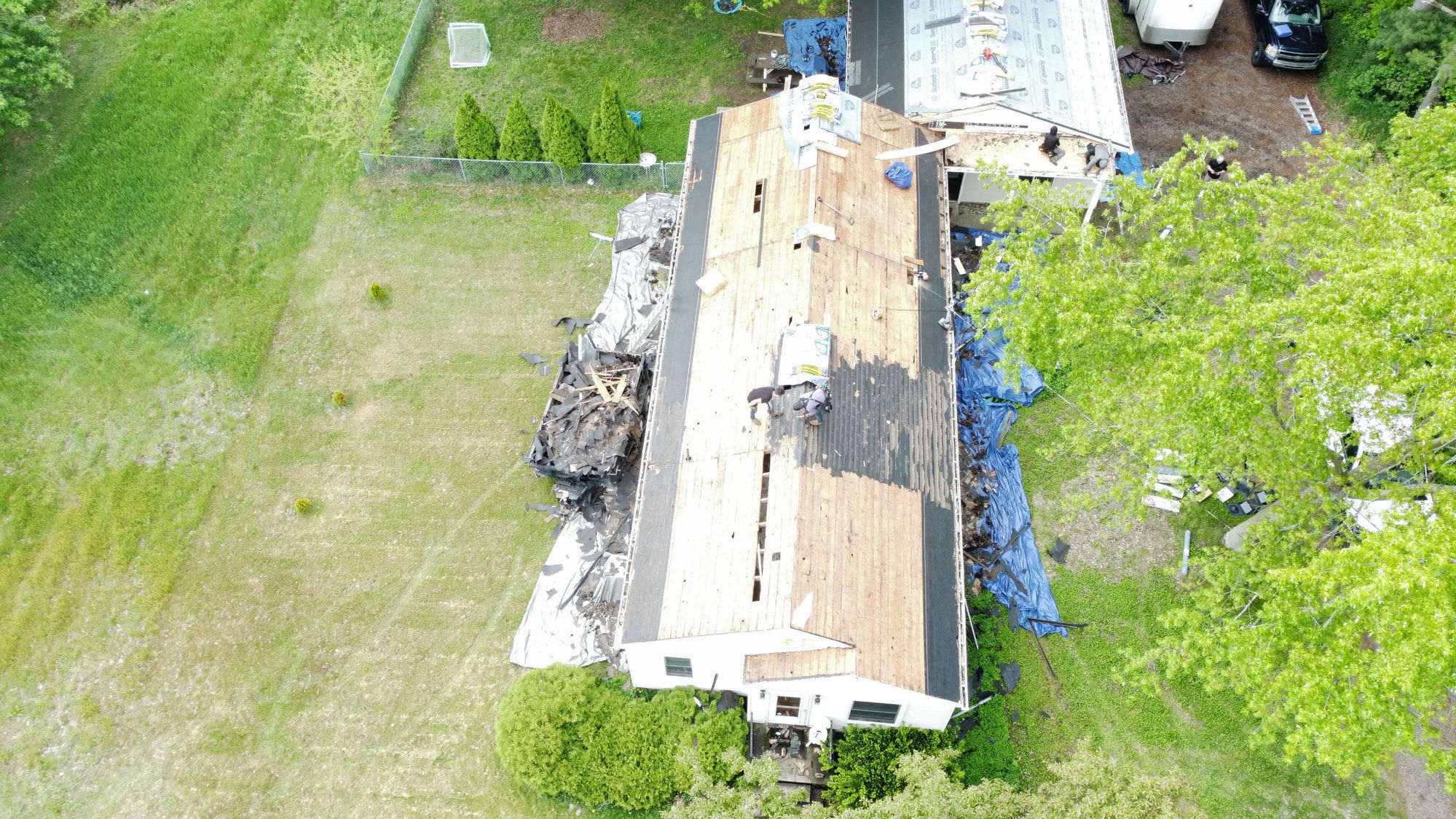 Roofing crew on active tear-off job — Nelson Remodeling & Services